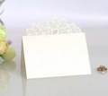Detail of laser-cut rose floral wedding place card with pearlescent finish and blank space - Ivory