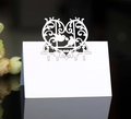 Detailed view of white laser-cut wedding place cards with heart and bird patterns - White