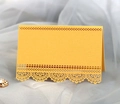 Elegant laser-cut yellow place cards with intricate lace hollow patterns on mesh fabric - Gold