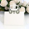 Detail of laser-cut white wedding place card with carriage design and couple silhouette - Ivory