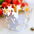 Detailed close-up of white star-shaped hollow lace cupcake wrapper for party decoration - White