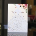 Detail of laser-cut wedding invitation featuring a bride silhouette with floral patterns - White