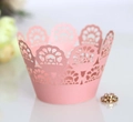 Detailed close-up of pink laser-cut cupcake wrappers with elegant floral lace patterns - Pink