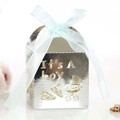 Close-up of silver laser-cut 'It's A boy' candy box with blue ribbon for baby shower - Reflective Silver