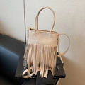 Retro beige bucket bag with fringe tassels, featuring round handles and a crossbody strap - Khaki