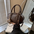 Chocolate brown Boston bag in textured faux leather with adjustable strap and charm - With Charm / Brown