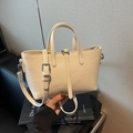 Chic cream-colored leather tote bag with decorative buckle strap for daily commuting - Off-white