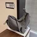 Dark grey pleated croissant bag with adjustable knot strap and minimalist crescent shape - Gray