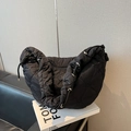 Black quilted puffer tote bag with heart embroidery and metallic eyelet details - Black