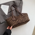 Vintage leopard print suede tote bag with brown leather handles on a grey blazer - Leopard Green