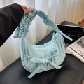 Light blue pleated cloud handbag featuring a decorative bow and soft fabric texture - Blue