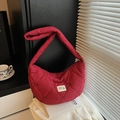 Red heart-quilted puffer shoulder bag with a crescent moon shape and brand patch - Red