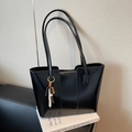 Glossy black PU leather tote bag with boho bead charm and zip top on art books - With Charm / Black