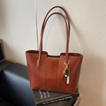 Brown leather large capacity tote bag with geometric stitching and beaded charm accessory - With Charm / Brown