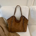 Deep brown suede tote bag with leather handles and metal buckle on a white sofa - No Pendant / Brown