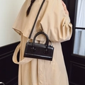 Glossy black handbag with circular metal accents and detachable crossbody strap - Black