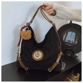Detail of leopard print hobo bag with brown leather straps and metal M logo - With Charm / Black
