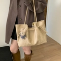 Detail of a large cream tote bag with a cute plush dog pendant and smooth matte finish - With Pendant / Khaki
