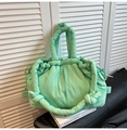 Close-up of light green quilted nylon tote bag featuring knotted padded handles - Mint Green