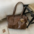 Minimalistische dunkelbraune Leder-Tote-Bag mit Bärenanhänger für herbstlichen Pendelalltag - Braun mit Anhänger