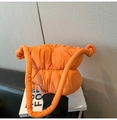 Detail of a bright orange puffer cloud bag with quilted nylon fabric and knot handle - Orange