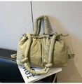 Detail of olive green quilted tote bag with drawstring closure and knot strap - Bean Green