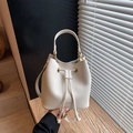 Creamy white bucket bag with pebble texture and drawstring closure in premium finish - White