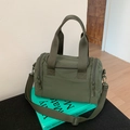 Close-up of military green nylon crossbody tote with durable straps and functional zippers - Green