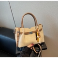 Detail of beige suede bucket bag with wooden bead charm and silver metal twist lock - With Pendant / Khaki