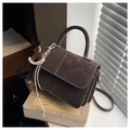 Close-up of brown vintage crossbody bag with white stitching and horse charm - Brown