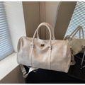 Detail shot of cream woven texture leather travel bag with dual metal zippers and handles - Off-white