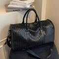 Large black woven travel bag with herringbone texture and adjustable shoulder strap - Black