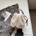 Chic beige faux fur bucket bag with brown leather drawstring and soft plush texture - White