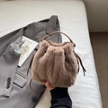 Brown faux fur bucket bag with drawstring closure and leather handle for autumn - Brown