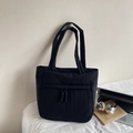 Large black nylon tote bag shown in a stylish workspace with laptop and headphones - Black
