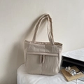 Quilted puffer tote bag in light beige featuring a padded texture and top handles - Off-white