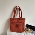 Caramel quilted tote bag for women with large front pocket and woven knot details - Orange