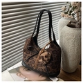Detail of leopard print handbag with black leather bow and plush charm accessory - With Charm / Leopard Print