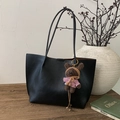 Close-up of black lychee texture tote bag featuring a cute brown plush bear charm - Black with Pendant
