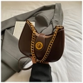 Detail of a brown leather hobo bag with a gold rotary clasp and vintage chain strap - Brown