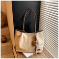 Close-up of beige suede tote bag with brown straps, plush bear charm and silk scarf - Beige With Charm