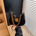 Elegant black crescent shoulder bag with gold chain strap and metallic twist lock - Black