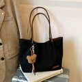 Large black canvas tote bag with brown straps, plush bear charm, and silk scarf detail - Black with Pendant