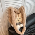 Cute bunny faux fur tote bag in brown and beige with striped legs on a black sofa - Khaki