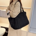 Minimalist large black canvas tote bag with wide shoulder strap for daily commuting - Black