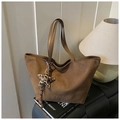 Detailed view of brown suede tote bag featuring FREE COLOR embossing and leopard star charm - Green with Pendant