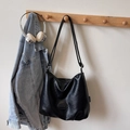Minimalist black tote bag with pleated texture and stylish shoulder straps in daily scene - Black (Without Charm)