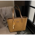 Detail view of large brown suede tote bag with leopard lining and wooden bead pendant - With Pendant / Brown
