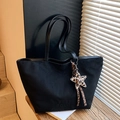 Minimalist black tote bag in matte finish with a leopard print star charm and logo - Black with Pendant