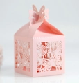 Close-up of pink laser-cut wedding candy box with intricate floral patterns and butterfly top - Pink